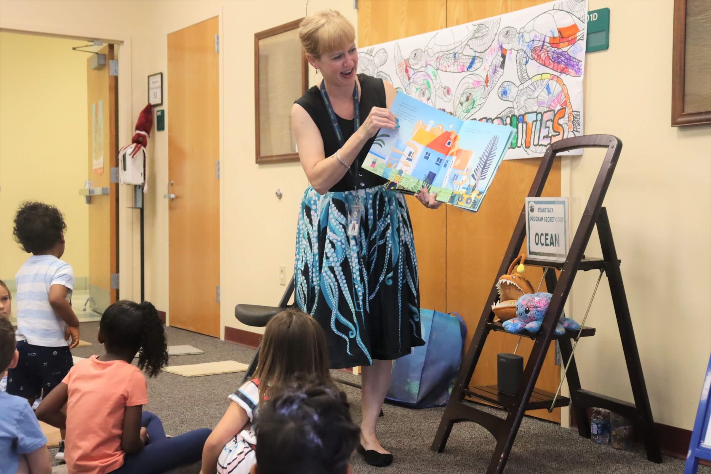 Central Ridge Youth Librarian Kim Roberts reads aloud to attendees of the “Creature Feature” program during Summer Reading.