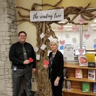 Library Director Eric Head and his mother, retired Homosassa Librarian Wylene Head stand by the 2021 Homosassa Reading Tree with the “hearts” that they donated to the collection.